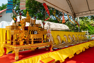 A set of golden altar tables and Buddha seats in religious ceremonial homes. There is a Buddha image placed on the worship table. Thai culture and religion in Thailand