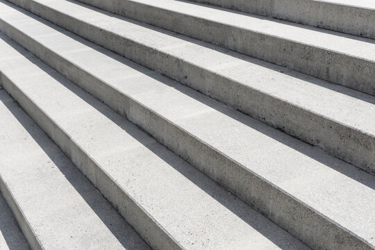 Concrete stairs texture. Leading upward. Urban architectural design. Stairway background. Stepway pattern. Sunlight stairway background.