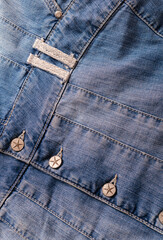 Fototapeta premium Detailed shot of a blue denim jacket with metal buttons