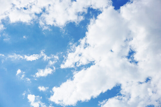 Milky sky with clouds resembling mist. Soft heaven texture of the sky. Hazy, foglike clouds providing a dreamy, heavenly atmosphere. Blue sky background. Bright clodus pattern.