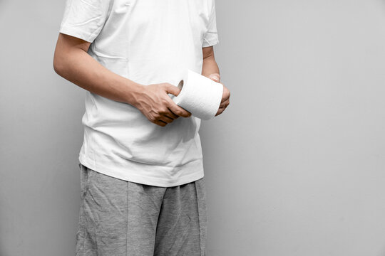 Man with toilet paper suffering from hemorrhoid in rest room, man has diarrhea holding his butt in toilet, diarrhea constipation. Men have diarrhea and are looking for shit.