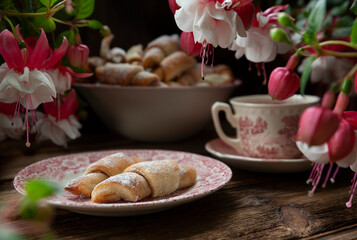 Sweet homemade mini croissants sprinkled with powdered sugar.