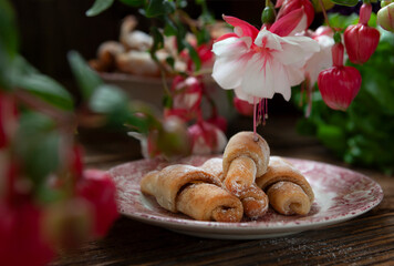 Sweet homemade mini croissants sprinkled with powdered sugar.