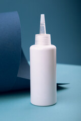 Shampoo scrub for hair bottle on blue background. Cosmetics products mock-up for branding.