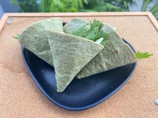 Dried pork and egg with salad in spinach funnel tortilla