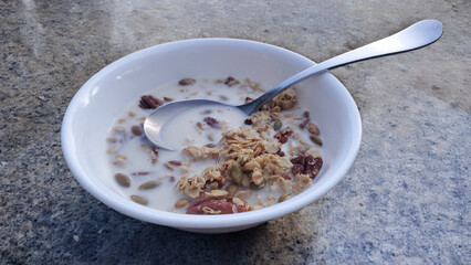 spoon in granola cereal on stone table, breakfast, oats, multi grain, nutrition, eating