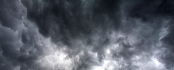 Banner Dramatic dark storm clouds black sky background. Dark thunderstorm clouds rainny season. Panorama Meteorology danger windstorm disasters climate. Dark cloudscape storm cloud with copy space.