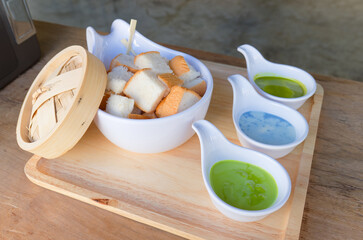 Steamed toast with pandan custard, served in a restaurant, traditional Thai dessert