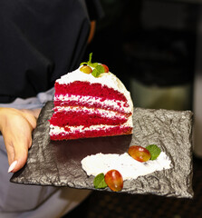 A female chef baking and eating a piece of homemade carrot cake