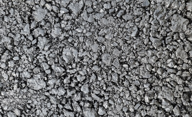 New laid asphalt road, large crushed stone.  Close-up. Background.