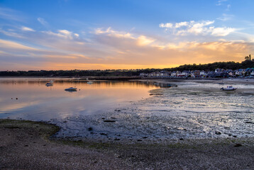 Serene coastal village of Cancale in french Brittany at sunset.