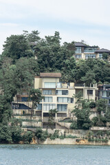 Fototapeta premium residential building on hill by lake