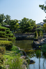 Fototapeta premium View of the pond and garden in Namsangol Hanok village, a recreated village of historical Korean buildings in Seoul, South Korea