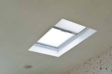 Indoor ceiling with a skylight, bringing in natural light to the room.