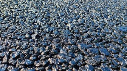 New laid asphalt road, large crushed stone.  Close-up. Background.