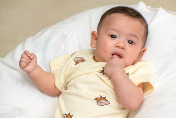 Thumbs or fingers sucking in baby newborn habit for calm and relax.