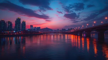 Fototapeta premium A vibrant cityscape at dusk, with a river reflecting the city lights and the colorful sky.