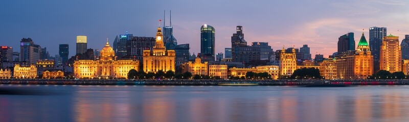 The Shanghai Bund International Buildings are illuminated by lights at night.