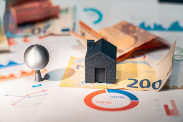 Housing market, real estate prices. Business analytics. Euro banknotes and documents on table.