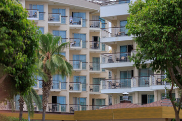 City view on a sunny day. Modern building and houses against the blue sky.
