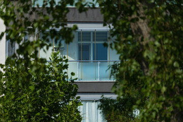 City view on a sunny day. Modern building and houses against the blue sky.