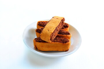 Indian gujarati traditional spice stuffed tea time Snacks food Bhakarvadi or Bakarvadi samosa in dish Diwali snacks Bhakharwadi in white background,top view