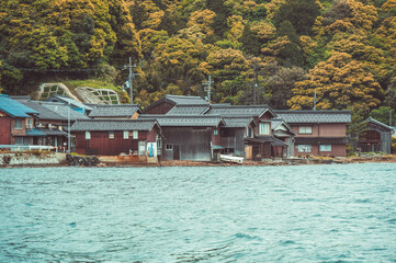 Beautiful scenic view with the wooden traditional waterfront boat houses called funaya around Ine Bay, in the village Ine, Japan