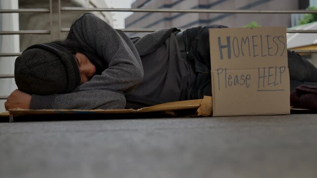 Homeless man praying to god for help people poverty beggar man asking for money job and hoping help in helpless dirty city sitting on street. Close up hands of homeless man praying beggar in city life