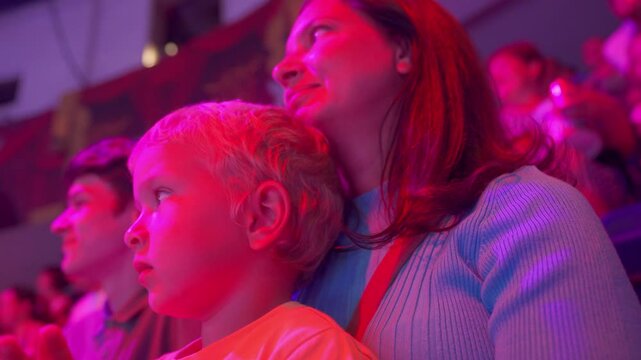 Spectators in a circus. Happy family with small child watching a circus performance. Little boy at circus. Simferopol, Crimea, Russia 2024
