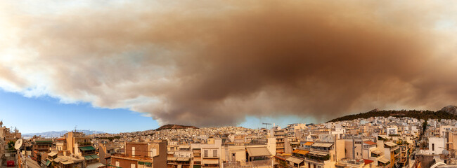 Thick smoke from wildfires in Varvanas and Grammatiko regions engulfs the sky over Athens, Greece,...