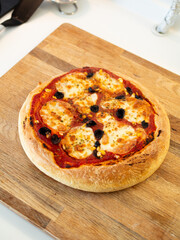 Fresh, hot, oven-baked Italian Neapolitan pizza with mozzarella cheese