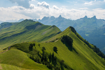 Fototapeta premium The Stoos hike in summer offers breathtaking views of the Swiss Alps, lush green meadows, and serene lakes. The trail is accessible yet challenging, with panoramic vistas that make every step rewardin