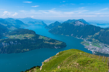 Fototapeta premium The Stoos hike in summer offers breathtaking views of the Swiss Alps, lush green meadows, and serene lakes. The trail is accessible yet challenging, with panoramic vistas that make every step rewardin