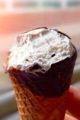 Close-up of bitten ice cream, vertical photo.