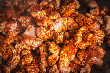 Turkey meat is fried in a pan. Background or banner, place to copy space, close-up.