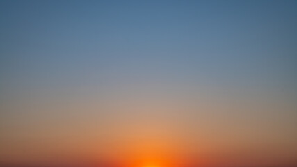 Natural background, sky at sunrise or sunset, color gradient from orange to blue, delicate and smooth transition