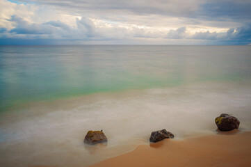 Aquamarine ocean with clouds in the sky