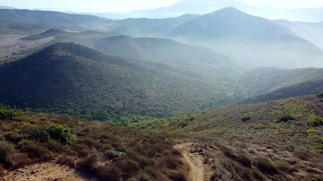 Drone Footage of Elevated Hiking Trail with Stunning Peak and Scenic Coastal Views