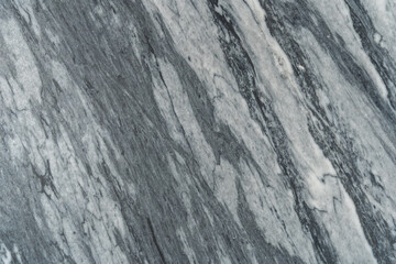 Gray marble texture with natural white veining patterns. Smooth, polished stone surface for countertops