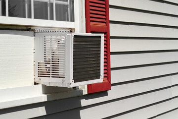 Fototapeta premium Air conditioner in house window on Summer day.