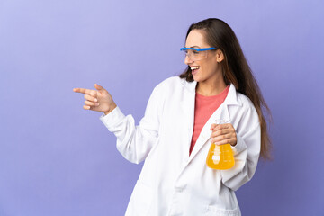 Young scientific woman over isolated background pointing finger to the side and presenting a product