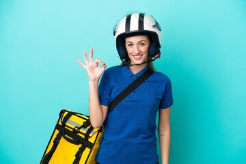 Young caucasian woman with thermal backpack isolated on white background showing ok sign with fingers