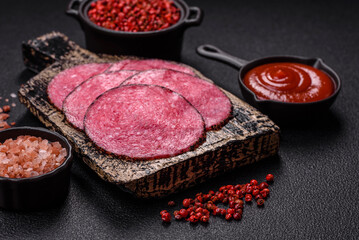Delicious smoked salami sausage sliced with salt, spices and herbs