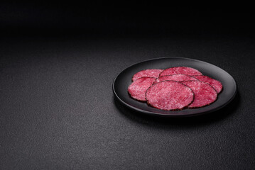 Delicious smoked salami sausage sliced with salt, spices and herbs