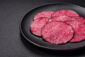 Delicious smoked salami sausage sliced with salt, spices and herbs