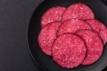 Delicious smoked salami sausage sliced with salt, spices and herbs