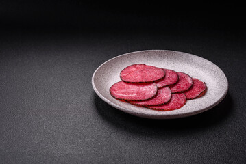 Delicious smoked salami sausage sliced with salt, spices and herbs