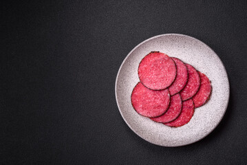Delicious smoked salami sausage sliced with salt, spices and herbs
