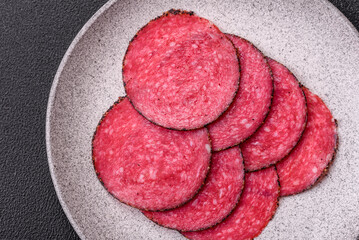 Delicious smoked salami sausage sliced with salt, spices and herbs