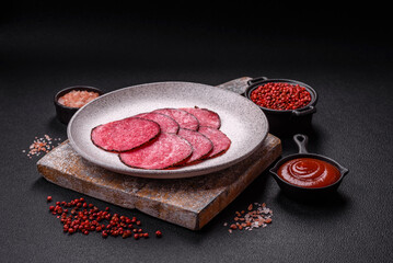 Delicious smoked salami sausage sliced with salt, spices and herbs
